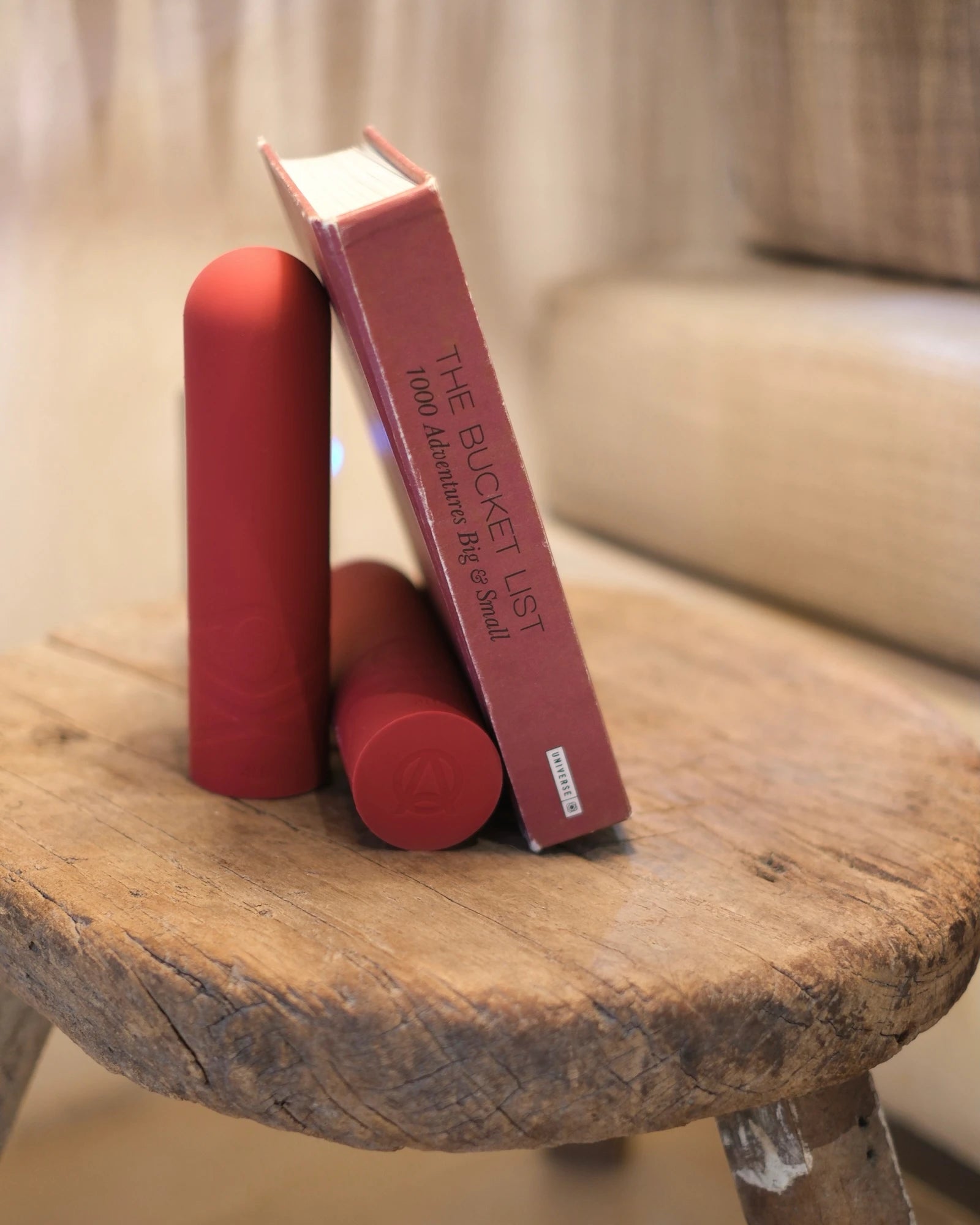 twi red silicone dumbbells holding a book on the table