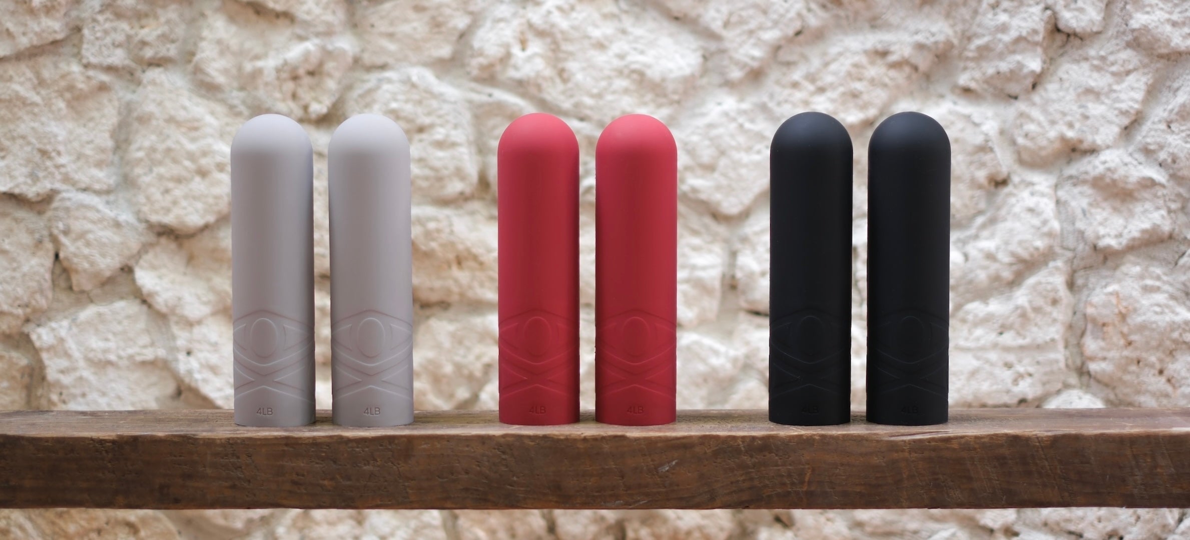 Three AVALATO silicone dumbbells in beige, red, and black