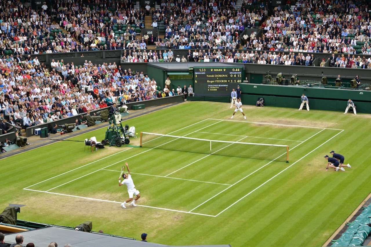 2 players playing tennis on the grass court on Wimbledon Tennis Championships